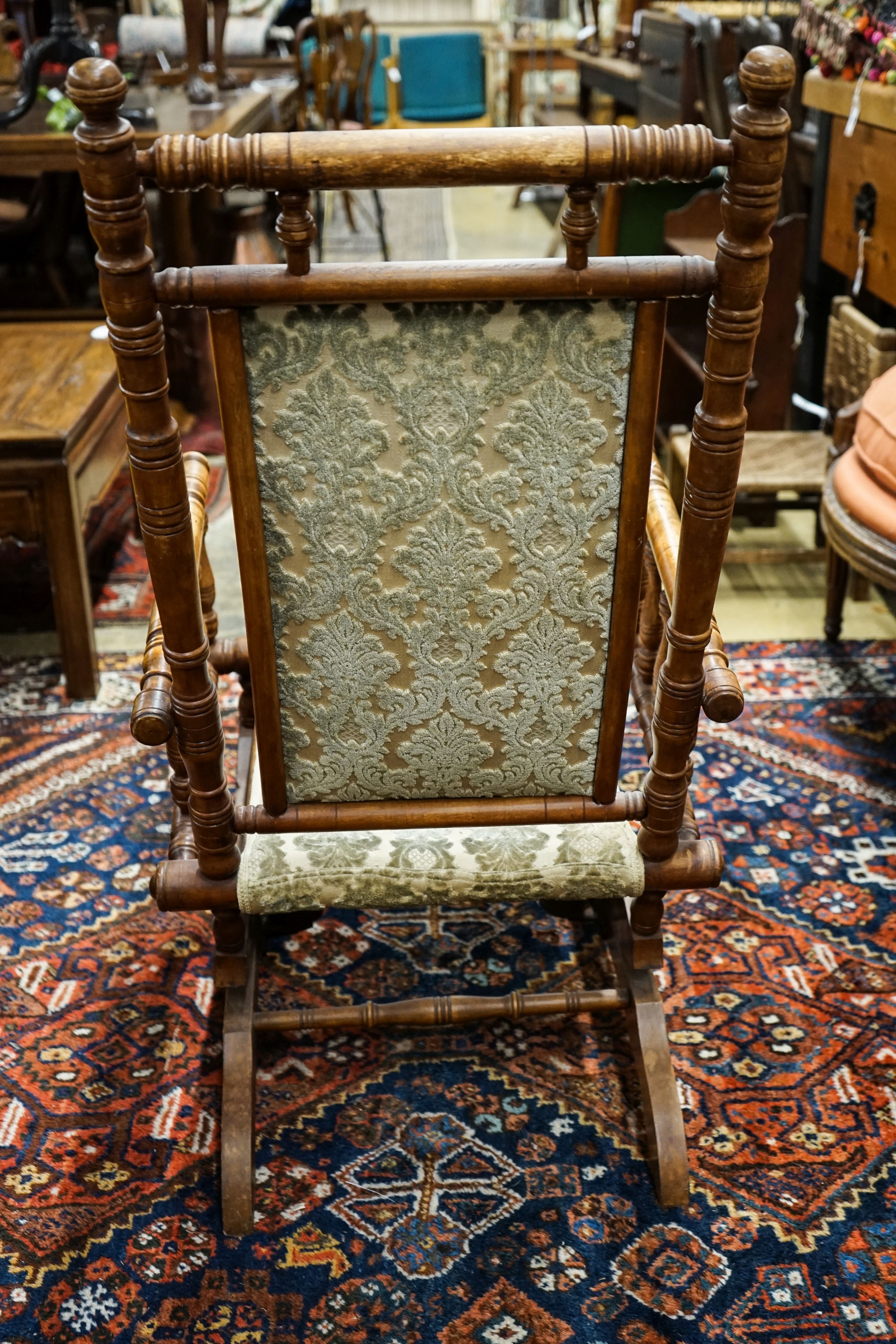 An early 20th century American rocking chair, width 54cm, depth 50cm, height 106cm